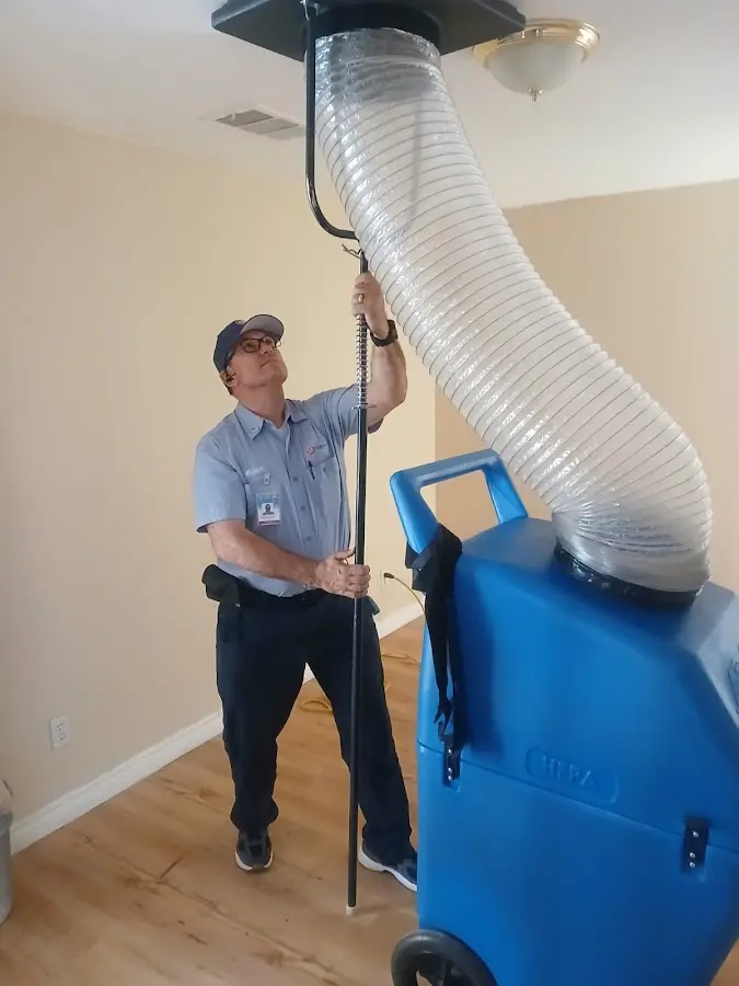 Furnace Tune-Up technician using HEPA equipment in Viera West